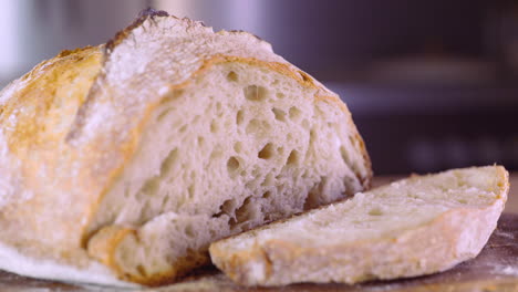 Freshly-Baked-Sourdough-Bread-Sliced-On-Wooden-Board---close-up,-slider-left-shot