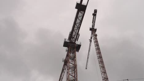 Low-angle-view-on-construction-crane-against-cloudy-sky