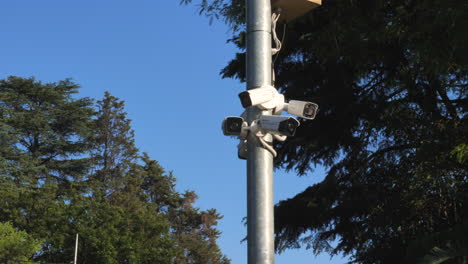 panning-shot-of-security-cameras-on-a-mast-drive-by