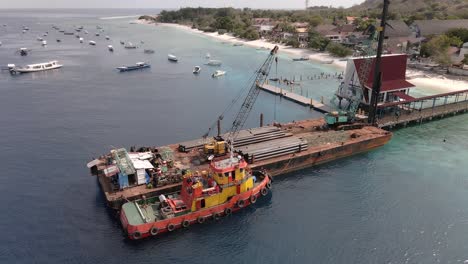 Aerial-water-pipe-construction-work-platform-loading-cargo-freight-at-pier-of-GIli-Trawangan,Indonesia-SLOWMOTION