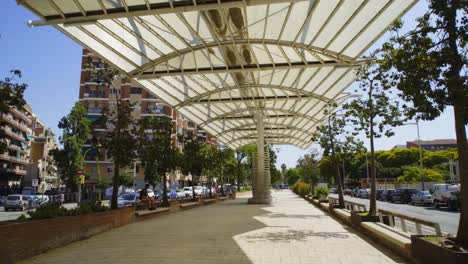 POV-walking-on-a-modern-boulevard-with-a-parasol-in-the-Sant-Marti-distric-in-Barcelona