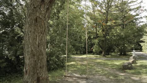 Walking-through-a-rope-tree-swing-in-the-back-yard-of-the-farmhouse