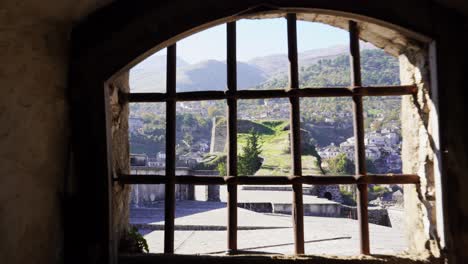 Prison-inside-medieval-castle-with-dungeon,-following-shot-toward-window-closed-by-iron-bars