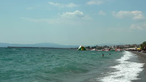 Wide-pan-shot-of-central-beach-of-Kalamata,-Peloponnese-,Greece,-summer-of-2020,-slow-motion