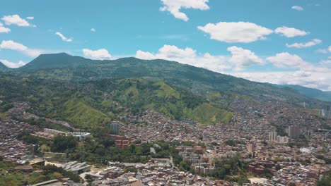 Drone-aerial-view-from-comuna-13-slums,-revealing-Medellin-city-in-Colombia