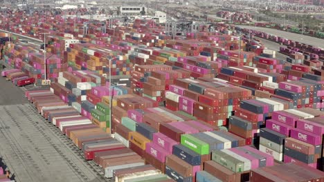 Drone-view,-containers-in-open-space,-at-shipping-harbor