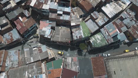 Drone-aerial,-flying-low,-bird's-eye-view-of-ghetto-slums-in-a-poor-area-of-Comuna-13,-Medellin,-Colombia