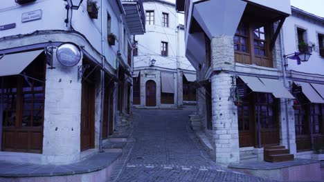 Cobblestone-narrow-alleys-through-beautiful-old-traditional-buildings-in-Bazaar-of-Gjirkastra