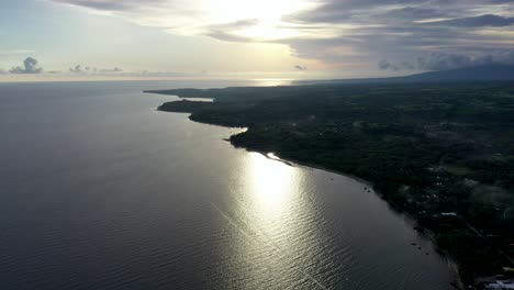 Stunning-Sunrise-Reflection-On-Calm-Sea-In-Negros-Oriental,-Philippines---aerial-drone