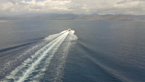 Aerial-tracking-shot-of-speedboat-passing-the-Indian-Ocean-during-sunny-and-cloudy-weather