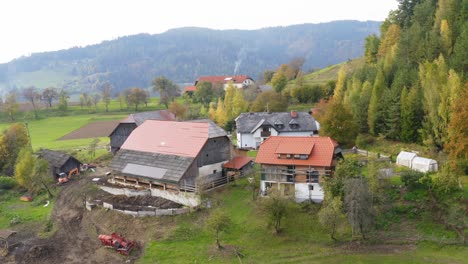 Aerial-Of-Rural-Countryside-Farmhouses-In-Prevalje,-Slovenia