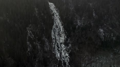 Stream-With-Melting-Snow-Flowing-Through-A-Mountain-Landscape-In-Vallee-Bras-du-Nord-In-Quebec,-Canada---Aerial-Drone-Shot