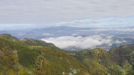 Clouds-on-the-mountain-ridge-shot-from-a-drone-at-Eisenkappel-Vellach,-Austria