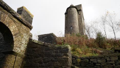 Landmark-Rivington-pigeon-tower-tall-English-rural-autumn-historic-fairy-tale-building-low-angle-left-dolly