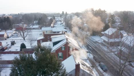 Cold-winter-morning-as-smoke-and-steam-billow-from-chimneys-of-homes-in-quiet-town-neighborhood