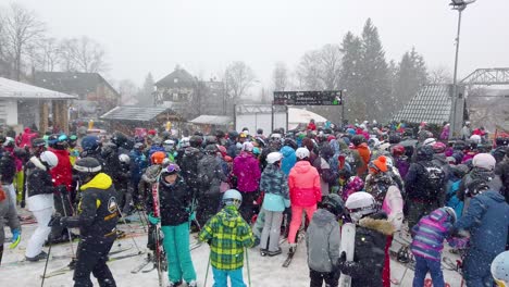 Huge-crowd-of-skiers-queuing-up-to-the-Szrenica-mountain-chairlift-in-Szklarska-Poreba-resort-during-winter-school-holidays,-Karkonosze-mountains,-Poland