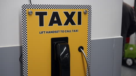A-taxi-telephone-call-phone-is-on-the-wall-in-a-supermarket