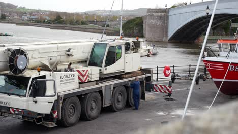 Hydraulic-extended-supports-on-crane-vehicle-on-Conwy-Wales-fishing-harbour