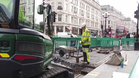 Pavement-widening-work-small-digger-and-workmen,-improvements-to-walking-and-cycling
