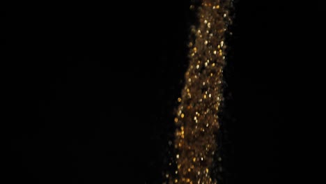 Gold-dust-falls-on-a-black-background