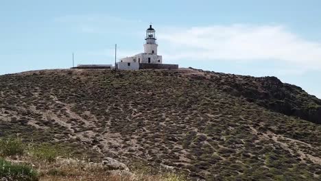 Aerial-Drone-Moving-Forward-With-Woman-Standing-Lighthouse