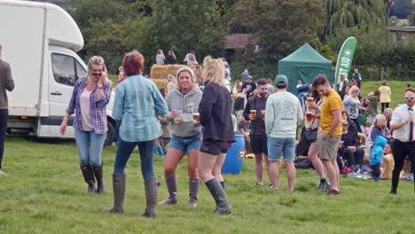 Young-girls-dance-and-drink-beer-during-Rotherham's-Farmfest