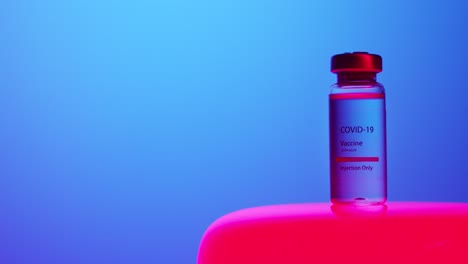 COVID19-vaccine-vial-on-LED-base-with-alternating-red-and-blue-colors