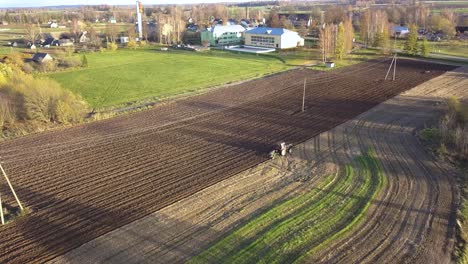 Tractor-Plowing-Agricultural-Farm-Fields.-Aerial-Approaching-View