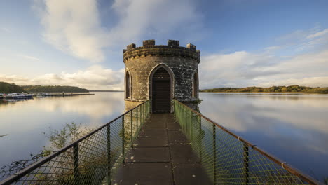 Time-lapse-of-a-medieval-tower-on-lake-with-dramatic-sky-in-rural-Ireland