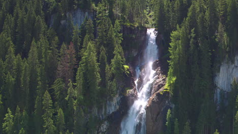 AERIAL-REVERSING-REVEAL-of-Iffigfall-waterfall,-Switzerland
