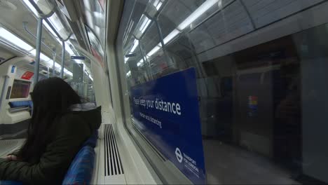 Inside-Window-View-Of-Train-Departing-Station-Platform-At-Bond-Street-Station,-London