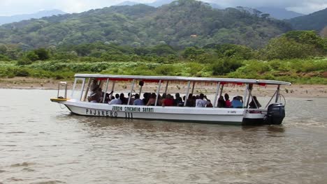 Passenger-boat-on-the-Tarcoles-River-in-Costa-Rica-taking-pictures-of-the-beautiful-landscape