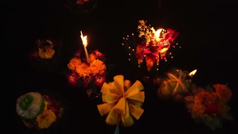 Loy-Krathong-Festival:-Top-down-Close-up-shot-of-Colorful-Krathongs-floating-on-the-water