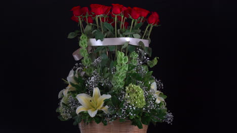 Roses-and-lily-arrangement-basket-bouquet-spinnin-wide-shot