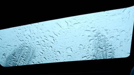 Wet-Car-Sunroof-On-Rainy-Day---Low-Angle-Shot,-Slow-Motion