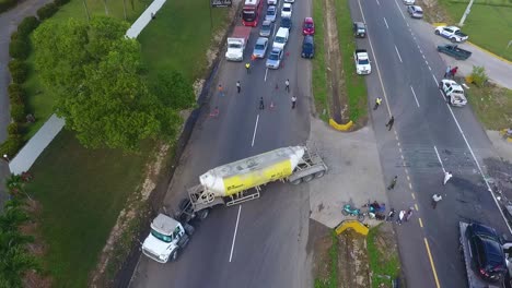 Aerial-view-of-a-truck,-leaving-a-traffic-accident-scene---tracking,-pan,-drone-shot