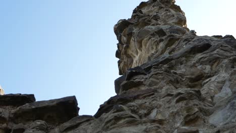 Looking-up-at-Sandal-Castle-ruins-against-blue-skies