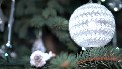 Glowing-Lighted-Ornament-Ball-On-Christmas-Tree
