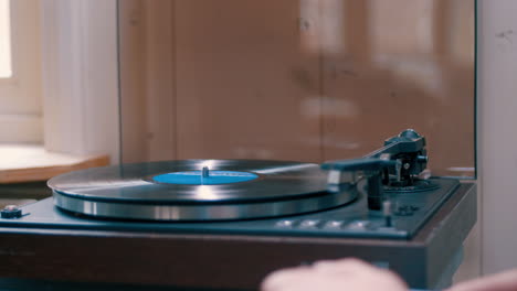 Placing-a-vinyl-record-on-a-record-player-to-listen-to-music