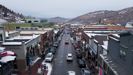 Snow-sport-tourists-in-busy-Park-City,-Utah-mountains,-aerial-winter-view