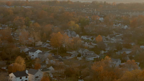 Aerial-of-a-nice-neighborhood-at-sunset-with-a-slow-rise-to-reveal-the-horizon