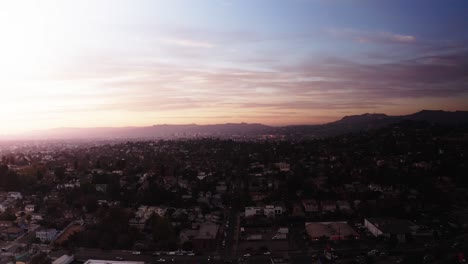 Aerial-wide-shot-of-the-city-of-Los-Angeles-looking-towards-Hollywood-during-sunset-in-2020