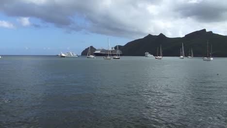 Cruise-ship,-small-yachts-and-sailboats-in-Taiohae-bay,-Nuku-Hiva,-Marquesas-Islands,-French-Polynesia