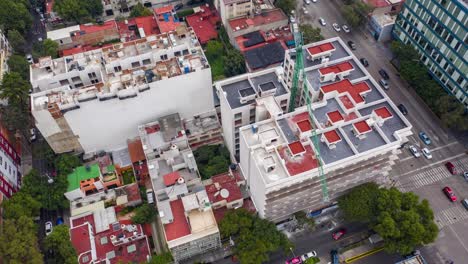 Aerial-Orbit-of-Apartment-Buildings-with-Green-Construction-Crane-in-Mexico-City