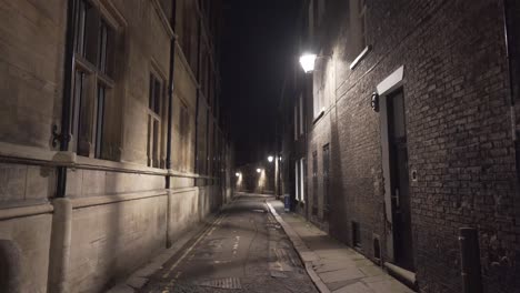 Narrow-street-alley-illuminated-in-cambridge-city-centre-england-uk