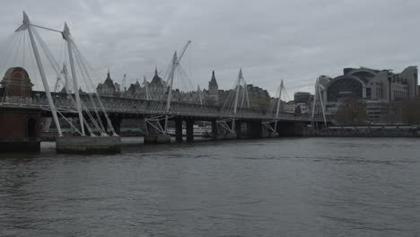 Hungerford-Bridge-and-Golden-Jubilee-Bridges-over-River-Thames-On-Downcast-Day