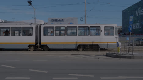 a-tram-crossing-the-street-in-Bucharest,-Romania
