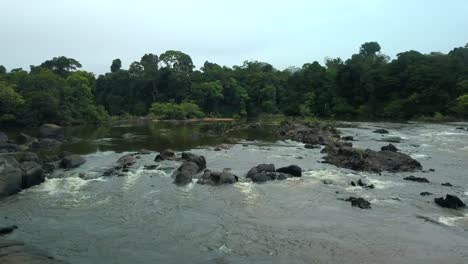 Suriname-river-rapid-flowing-through-jungle-rainforest,-aerial-view