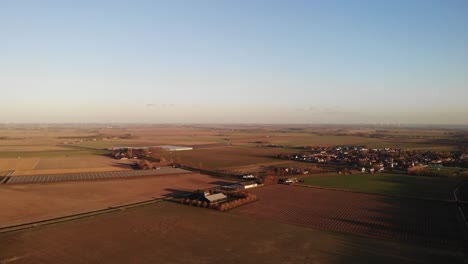 Aerial-dolly-shot-of-a-wind-turbine-and-a-landscape