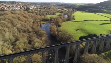 Old-Welsh-Pontcysyllte-Aqueduct-waterway-aerial-view-rural-Autumn-woodlands-valley-slow-right-dolly